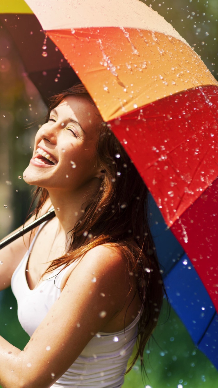 Happy Girl With Rainbow Umbrella Under Summer Rain wallpaper 750x1334
