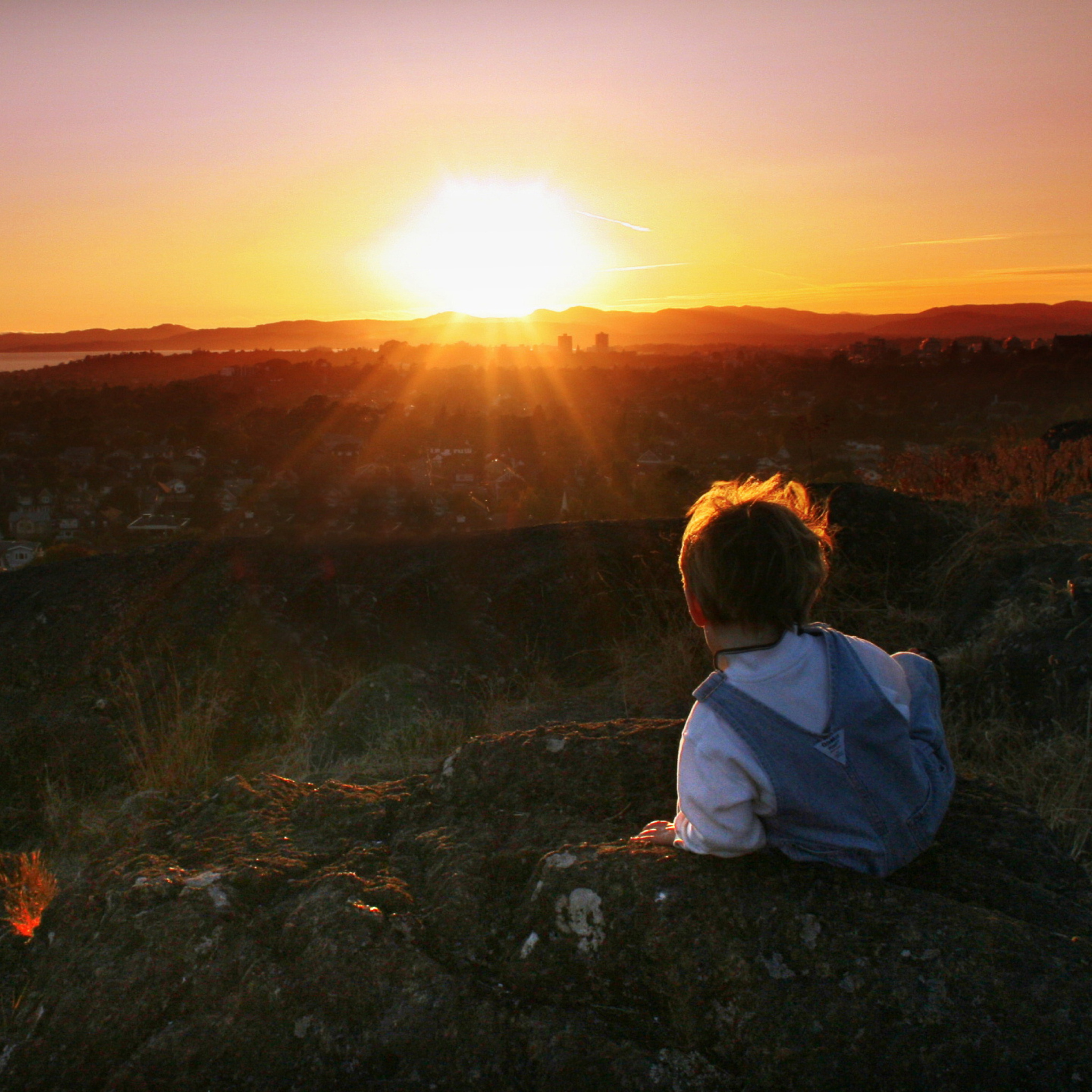 Little Boy Looking At Sunset From Hill wallpaper 2048x2048