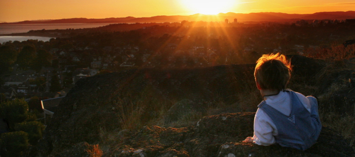 Little Boy Looking At Sunset From Hill wallpaper 720x320