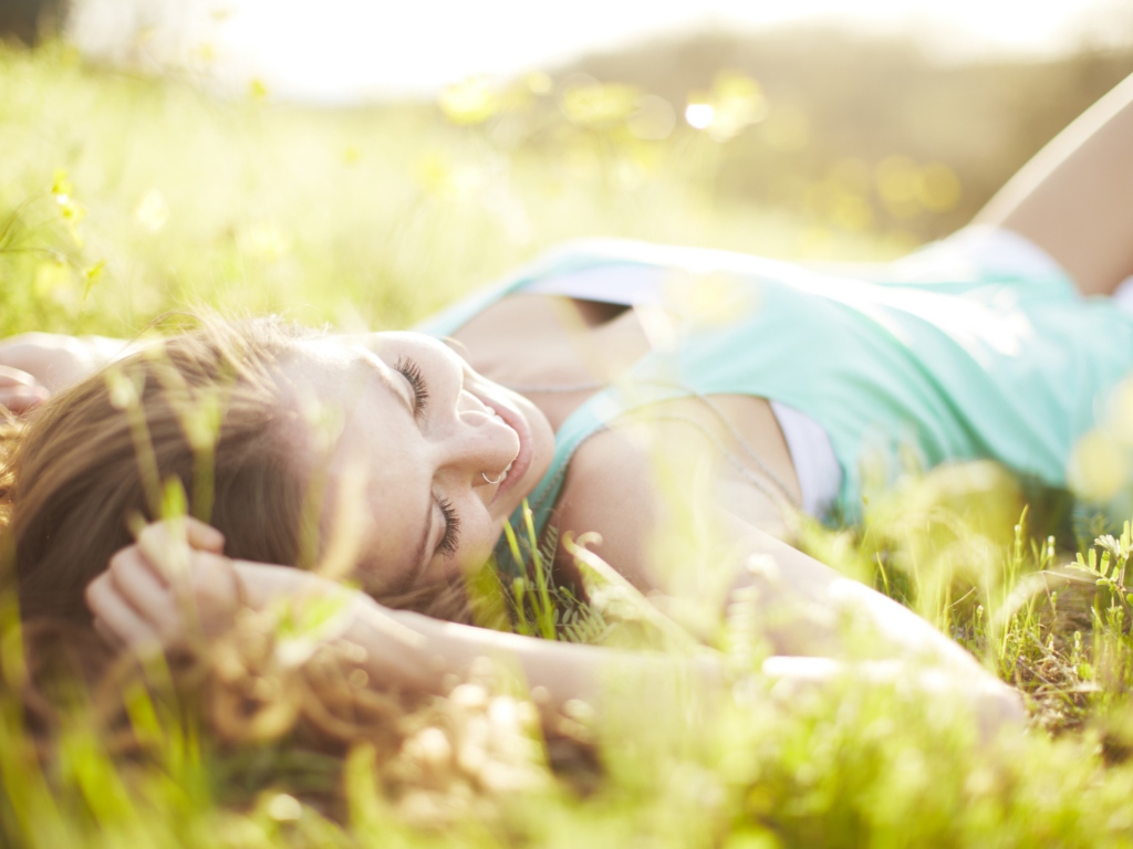 Happy Girl Lying In Grass In Sunlight screenshot #1 1024x768