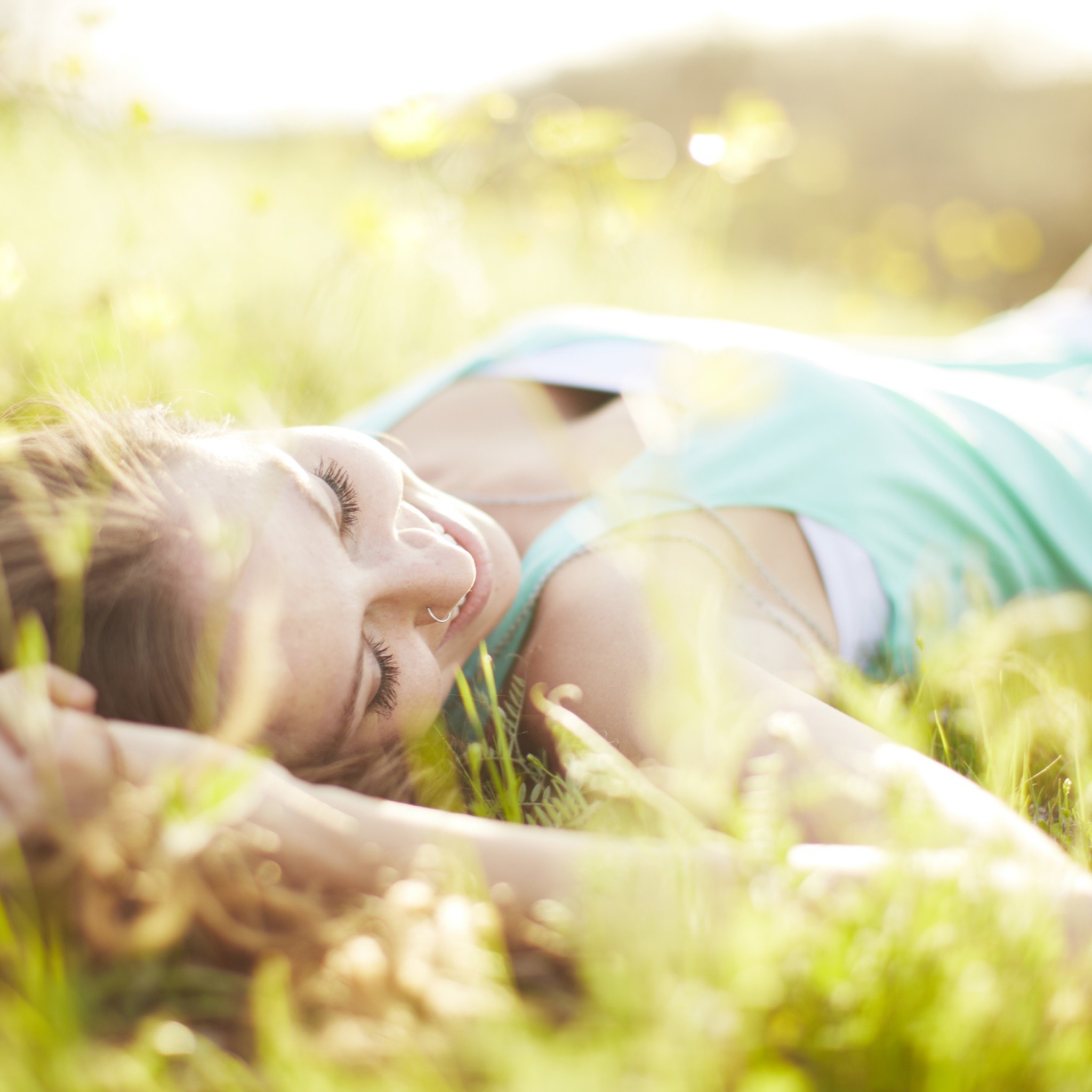 Sfondi Happy Girl Lying In Grass In Sunlight 2048x2048