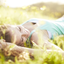 Sfondi Happy Girl Lying In Grass In Sunlight 208x208