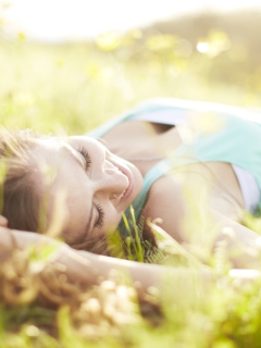 Das Happy Girl Lying In Grass In Sunlight Wallpaper 240x320