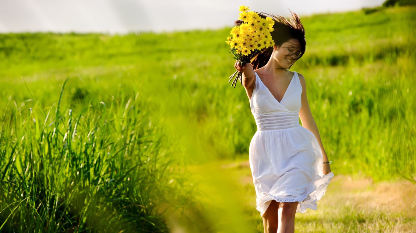 Girl With Yellow Flowers In Field wallpaper 1366x768