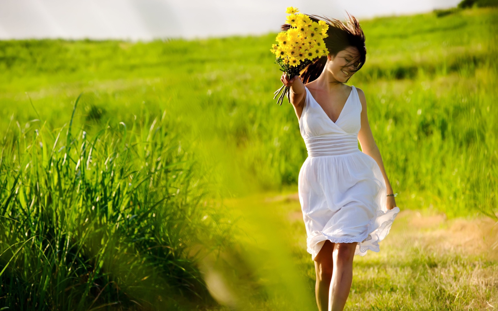 Girl With Yellow Flowers In Field wallpaper 1680x1050