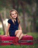 Das Little Girl Sitting On Red Suitcase Wallpaper 128x160