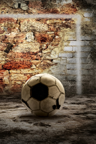 Обои Ball In Front Of Brick Wall 320x480