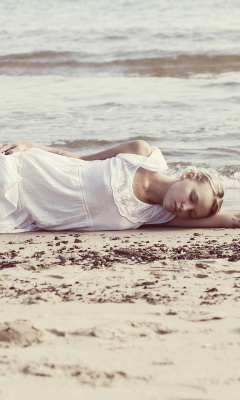 Обои Blonde Girl Lying On Beach 240x400