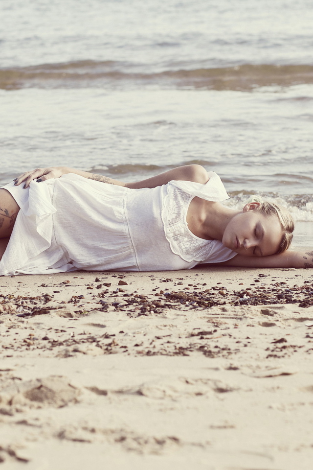 Blonde Girl Lying On Beach wallpaper 640x960