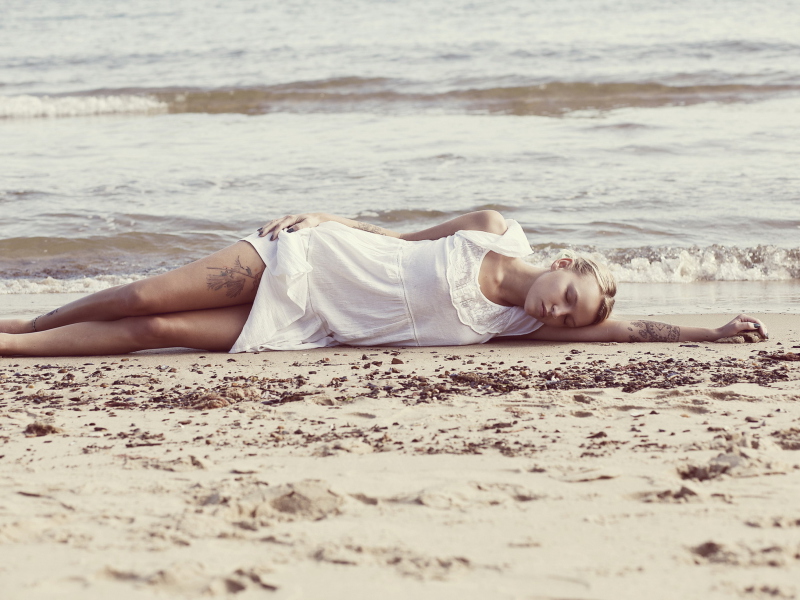 Sfondi Blonde Girl Lying On Beach 800x600