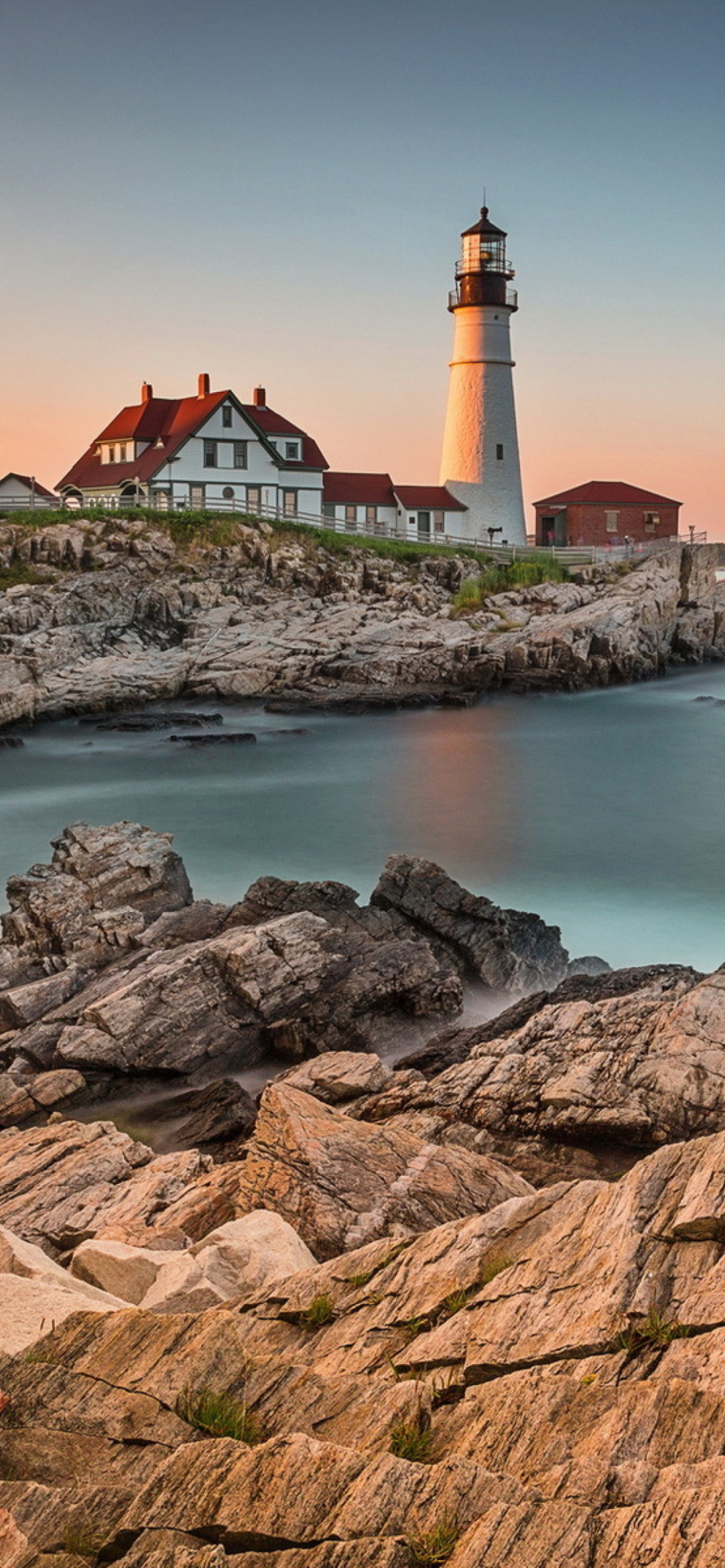 Lighthouse On Rocky Seashore screenshot #1 1170x2532