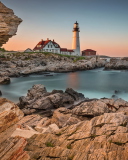 Lighthouse On Rocky Seashore screenshot #1 128x160