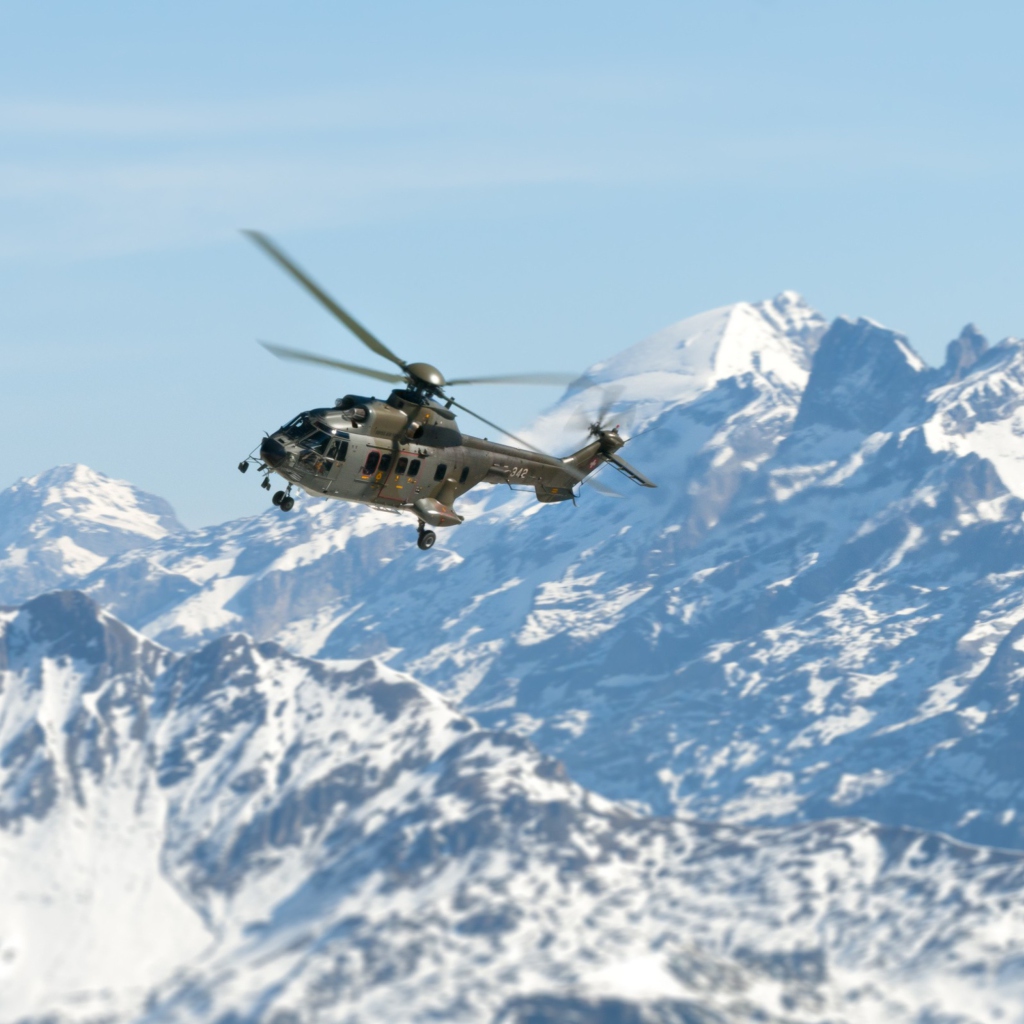 Обои Helicopter Over Snowy Mountains 1024x1024