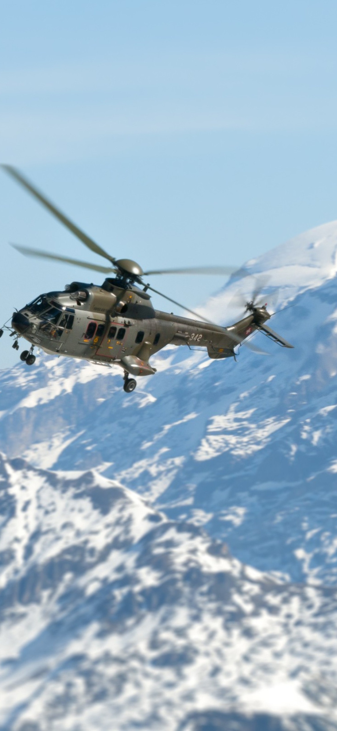 Fondo de pantalla Helicopter Over Snowy Mountains 1170x2532
