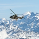 Fondo de pantalla Helicopter Over Snowy Mountains 128x128