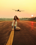 Airplane Over Girl's Head wallpaper 128x160