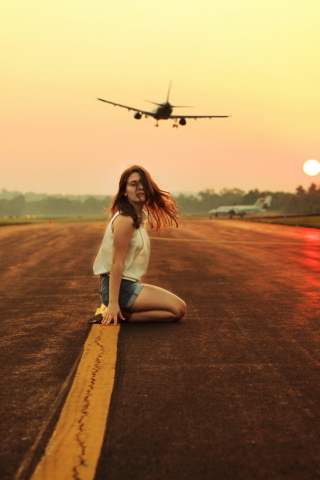 Airplane Over Girl's Head wallpaper 320x480