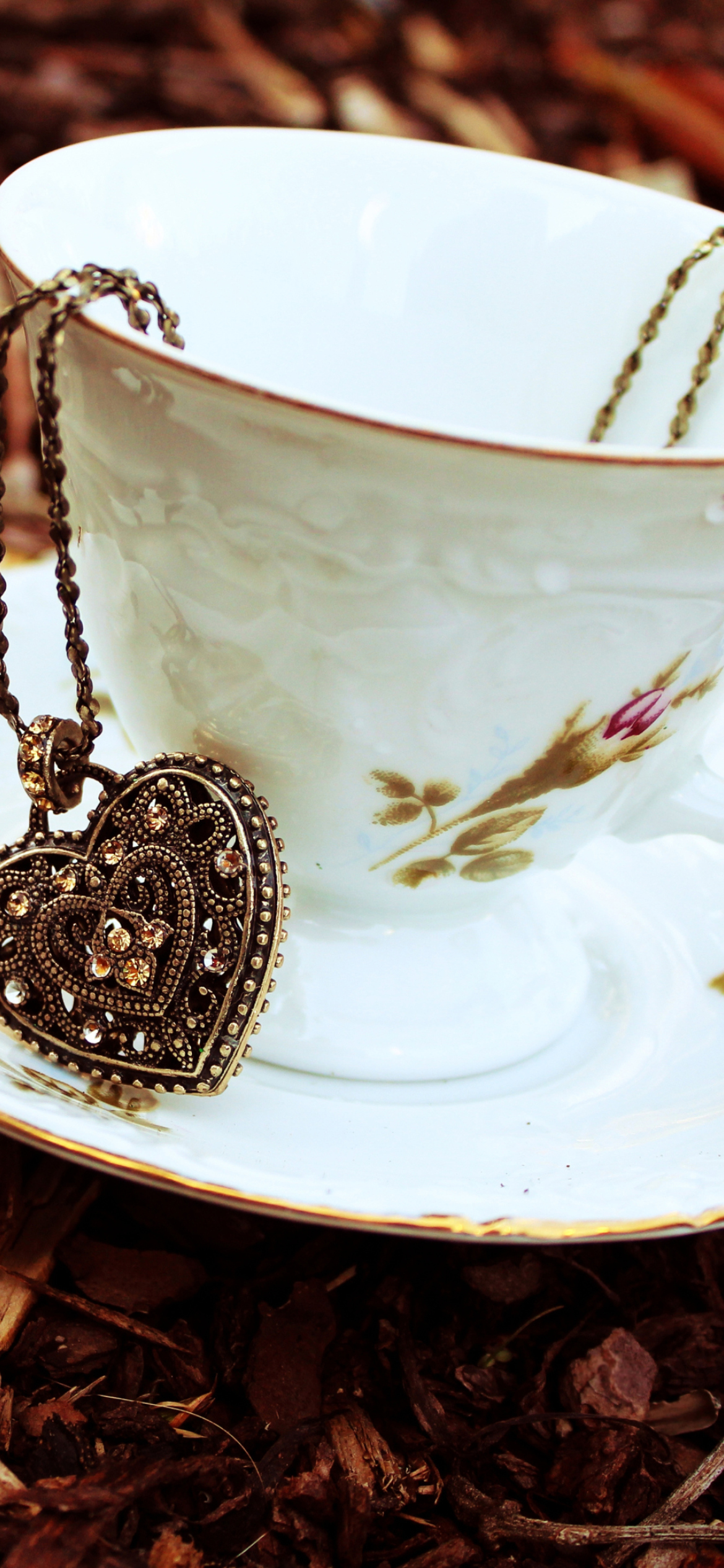 Heart Pendant And Vintage Cup wallpaper 1170x2532