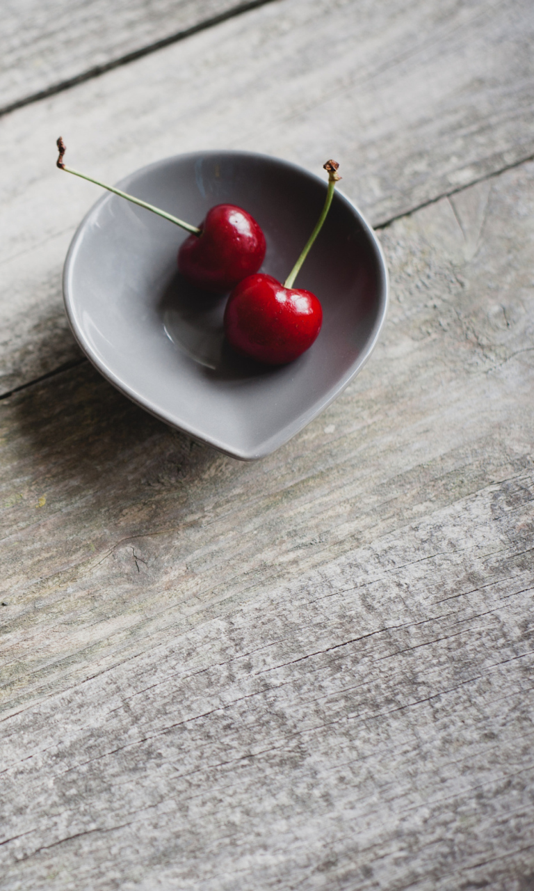 Обои Two Red Cherries On Plate On Wooden Table 768x1280