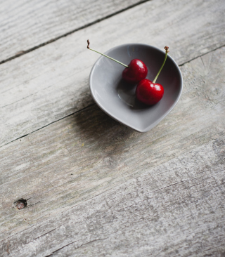 Kostenloses Two Red Cherries On Plate On Wooden Table Wallpaper für 1080x1920