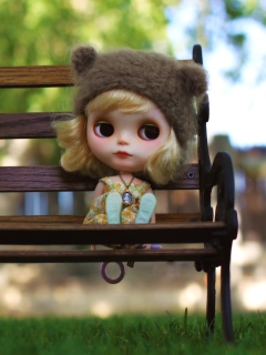 Fondo de pantalla Doll Sitting On Bench 240x320