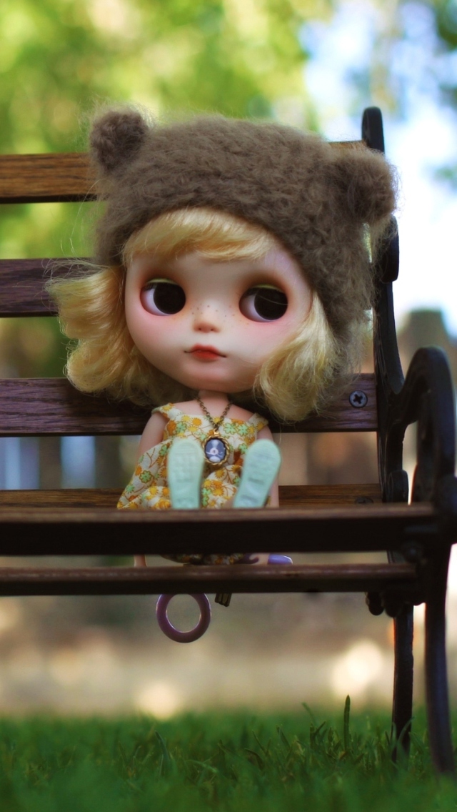 Das Doll Sitting On Bench Wallpaper 640x1136