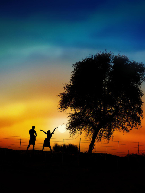 Couple Silhouettes Under Tree At Sunset wallpaper 480x640
