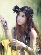Das Pretty Girl In Grass Playing Guitar Wallpaper 132x176