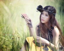 Pretty Girl In Grass Playing Guitar wallpaper 220x176