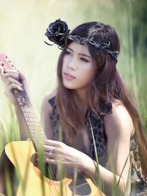 Pretty Girl In Grass Playing Guitar wallpaper 480x640