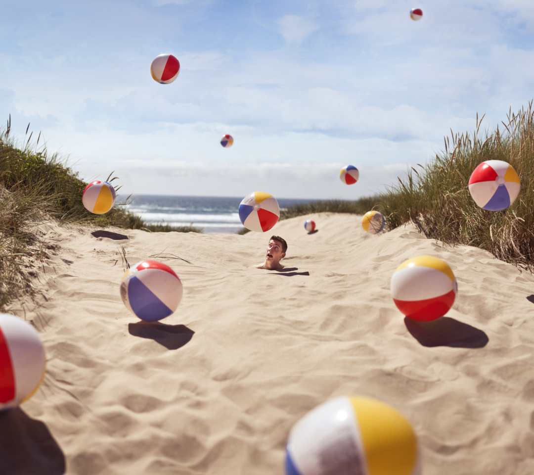 Sfondi Beach Balls And Man's Head In Sand 1080x960