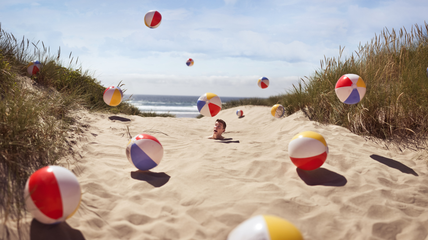 Das Beach Balls And Man's Head In Sand Wallpaper 1366x768