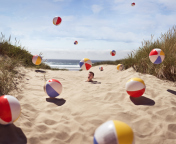 Sfondi Beach Balls And Man's Head In Sand 176x144