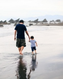 Father And Child Walking By Beach wallpaper 128x160