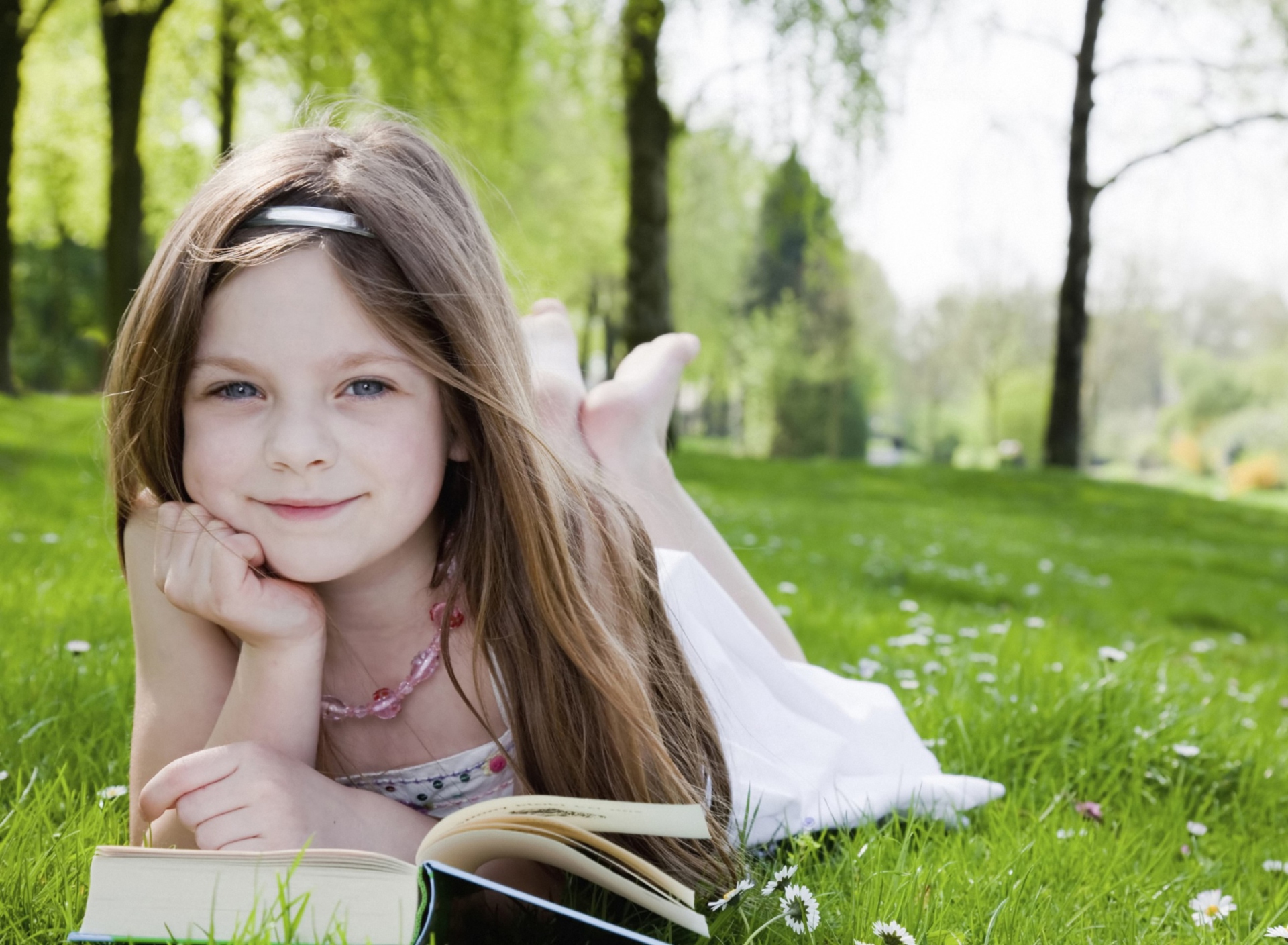 Cute Little Girl Reading Book In Garden wallpaper 1920x1408