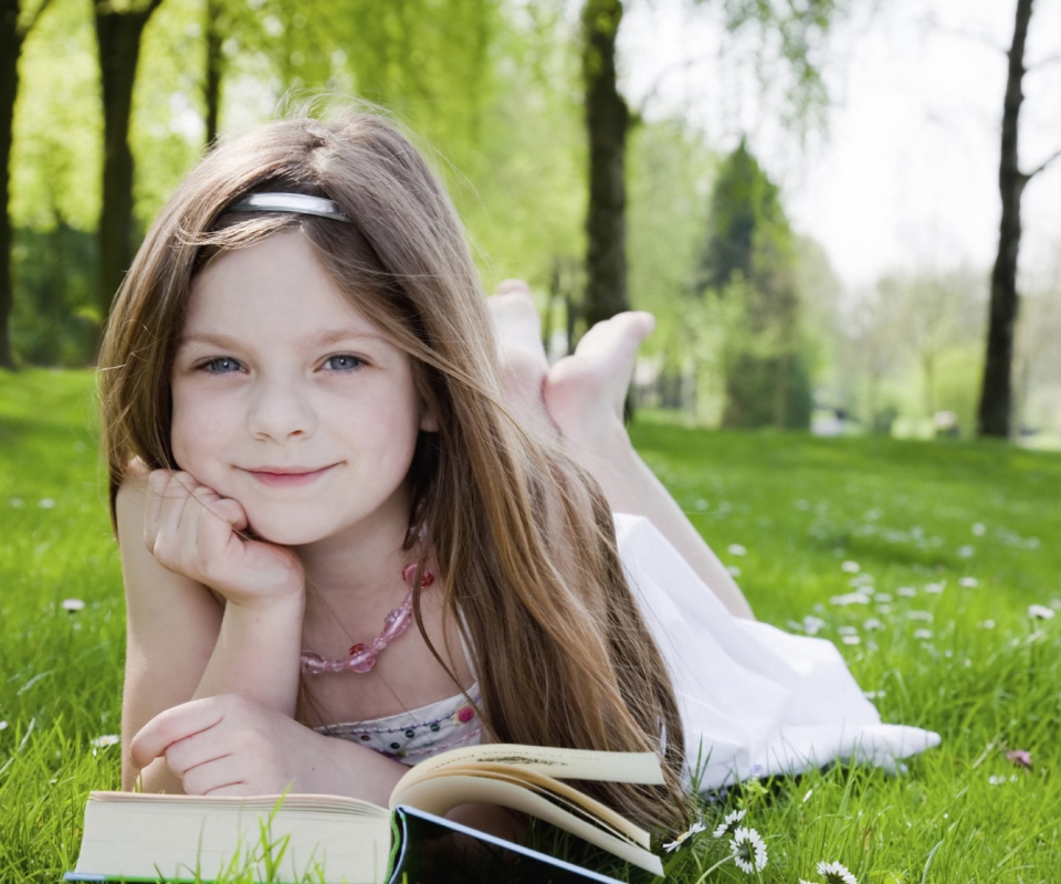 Cute Little Girl Reading Book In Garden wallpaper 960x800