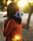 Girl With Two Blue Gerberas wallpaper 128x160