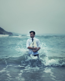 Man With Ship In Hands And Ocean Waves Around Him screenshot #1 128x160