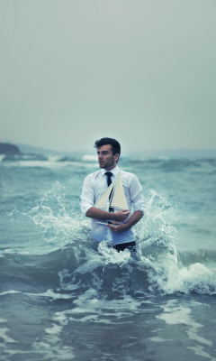 Обои Man With Ship In Hands And Ocean Waves Around Him 240x400