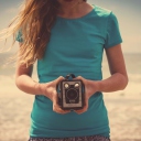 Sfondi Girl On Beach With Retro Camera In Hands 128x128