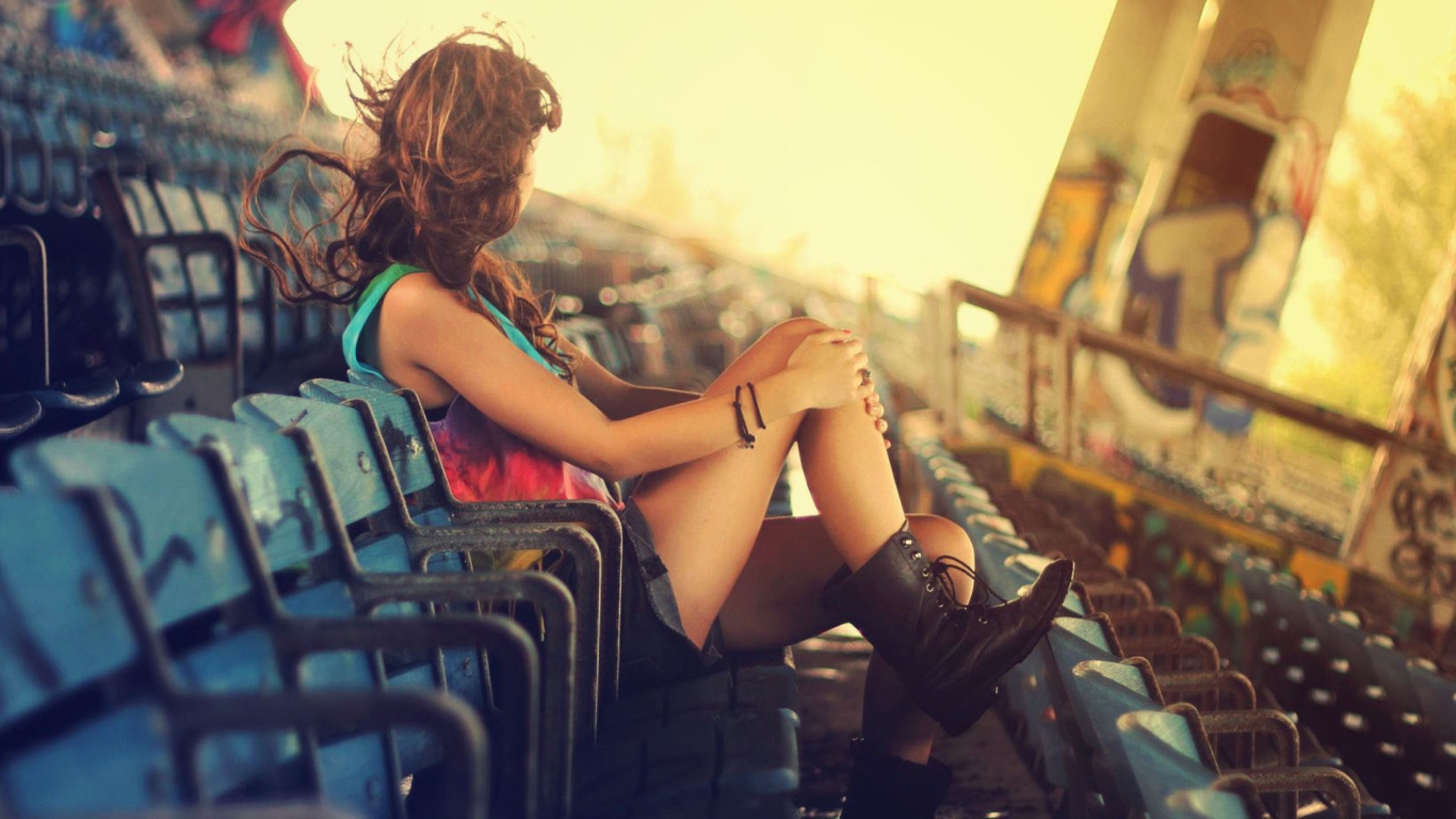 Обои Girl Sitting In Stadium 1366x768