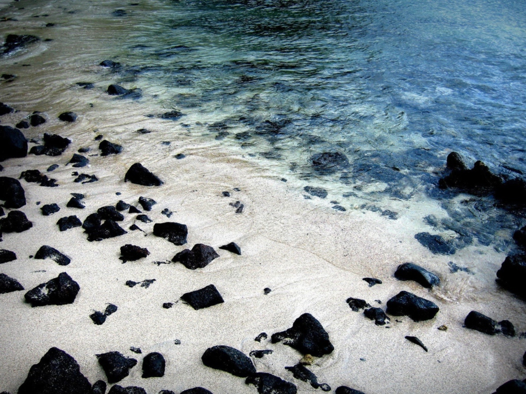 Black Stones On White Sand Beach wallpaper 1024x768