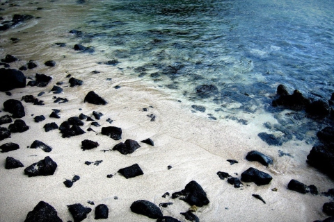 Black Stones On White Sand Beach wallpaper 480x320