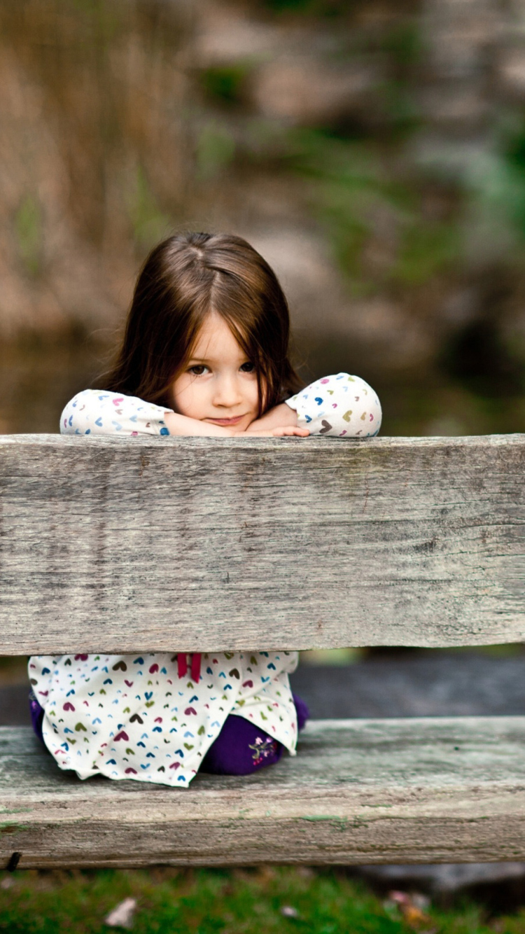 Child Sitting On Bench wallpaper 750x1334