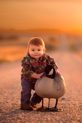 Kid and Duck wallpaper 320x480