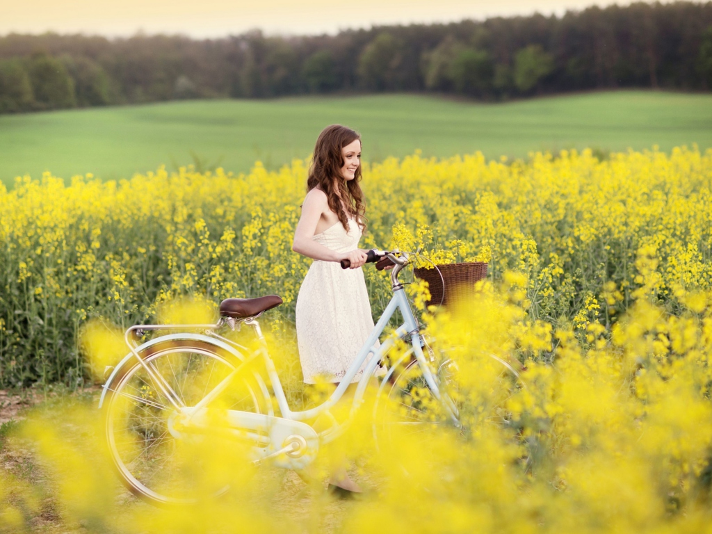 Sfondi Girl With Bicycle In Yellow Field 1024x768