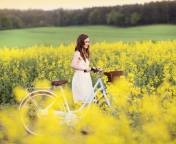 Screenshot №1 pro téma Girl With Bicycle In Yellow Field 176x144