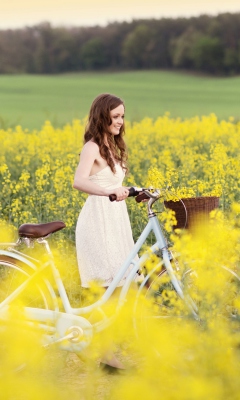 Sfondi Girl With Bicycle In Yellow Field 240x400