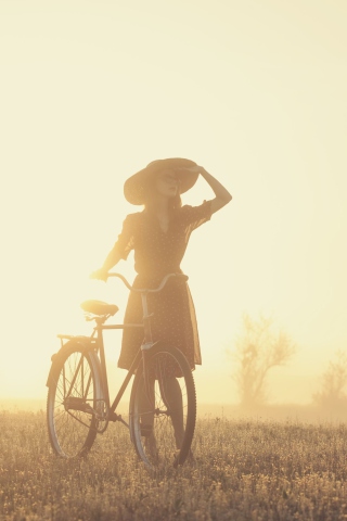 Girl And Bicycle On Misty Day wallpaper 320x480