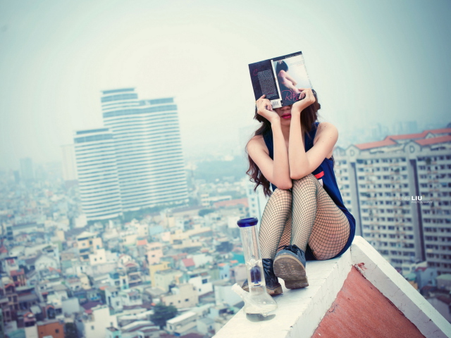 Fondo de pantalla Girl With Book Sitting On Roof 640x480
